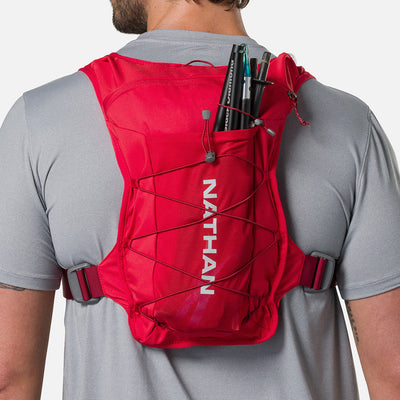 color:Ribbon Red/Reflective Silver||seo:Nathan QuickStart 3.0 6 Liter Hydration Pack - Ribbon Red/Reflective Silver - On Model - Large back expandable mesh pocket perfect for clothes, gear and other larger essentials, plus elastic pole keeper