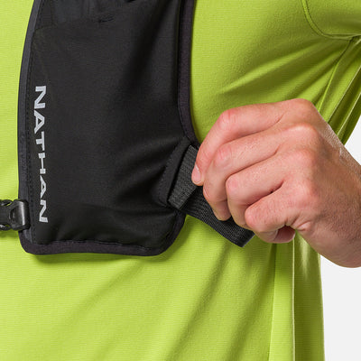 color:Black/Reflective Silver||seo:Nathan QuickStart 3.0 4 Liter Soft Flask Hydration Pack - Black/Reflective Silver - On Model - Closeup Detail View of Model Adjusting Wide Side Straps For a Secure No Bounce Fit