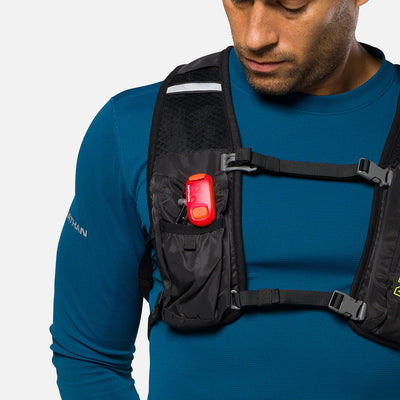 color:Ribbon Red||seo:Nathan StrobeLight 2.0 Safety LED Light Clip - Ribbon Red - On Model - Detail View of StrobeLight Attached to Vest