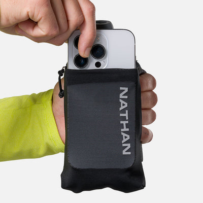 color:Black/Reflective Silver||seo:Nathan SpeedDraw 2 12oz Flask - Black/Reflective Silver - Model Pulling iPhone from Front Pouch