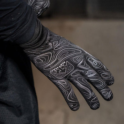 Closeup Shot of Runner Sliding On NATHAN Men's Black Reflective Gloves with Topography Design