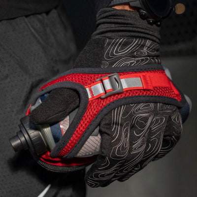Runner wearing NATHAN Men's Black Reflective Gloves with Handheld Hydration Flask