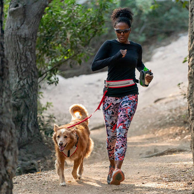 Female Runner /Jogger walking alongside Nathan K9 White-Red Dog Harness with Black Accents  with  Leash