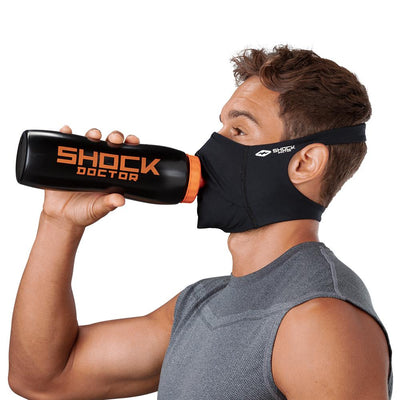 Black Play Safe Face Mask – Male Model Wearing Protective Safety Face Mask while Drinking a Hydration Water Bottle - Left Angle