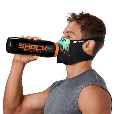 Drip Play Safe Face Mask – Male Model Wearing Protective Safety Face Mask while Drinking a Hydration Water Bottle - Left Angle